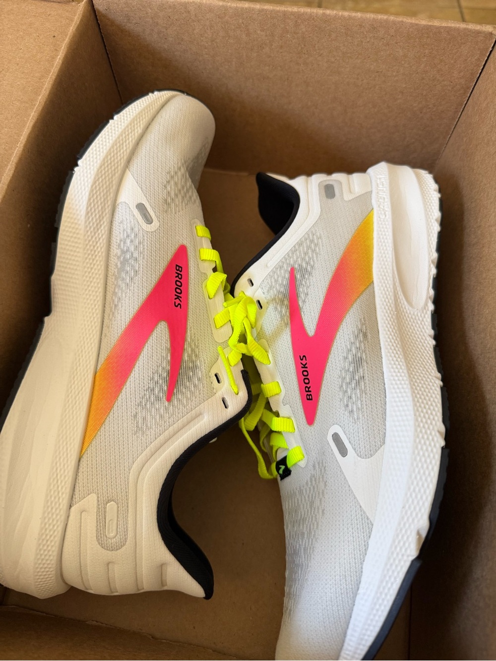 Brooks White Running Shoes with Neon Yellow Laces and Pink-Orange Accent